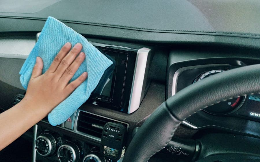 Hands fitting an accessory to a car