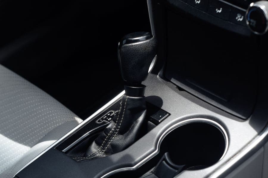 Close-up of a car center console with two open cup holders