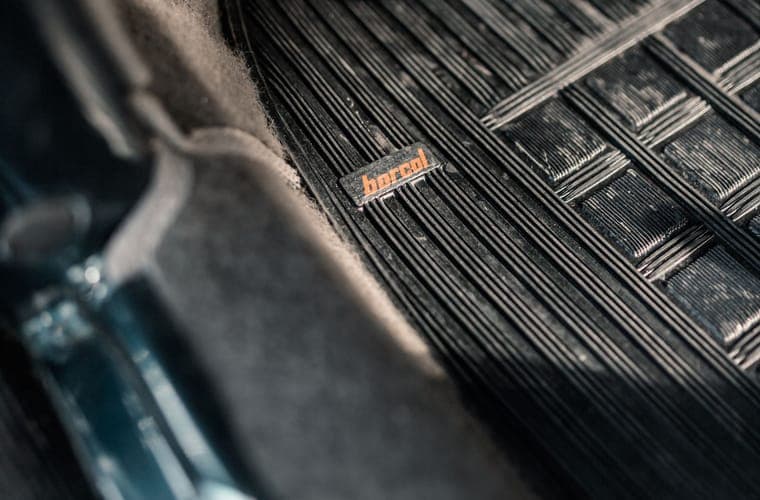 Textured car floor mat lit at an angle, showing its raised ribbing