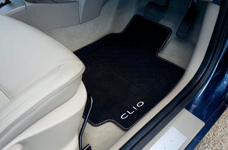 Fitted carpet floor mat in a car footwell