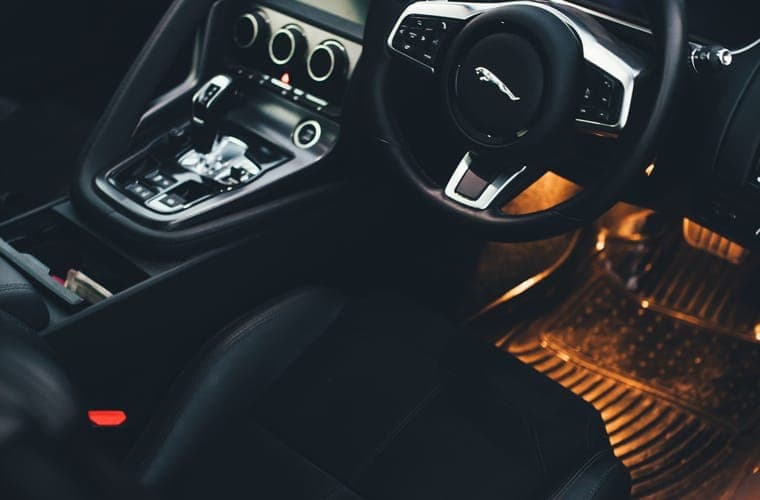 Modern car interior seen from the front seats, footwells visible