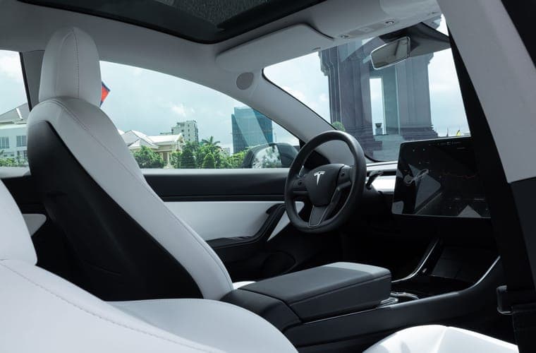 Pale electric-car interior with the rear seats in frame