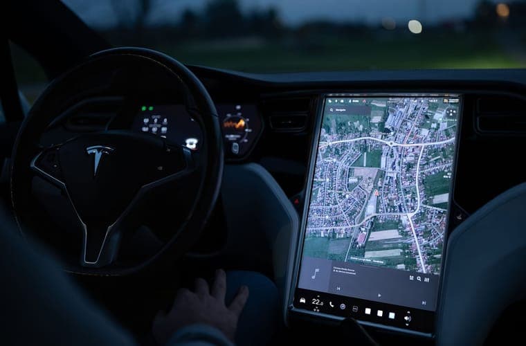 Electric-car touchscreen showing the navigation view at night