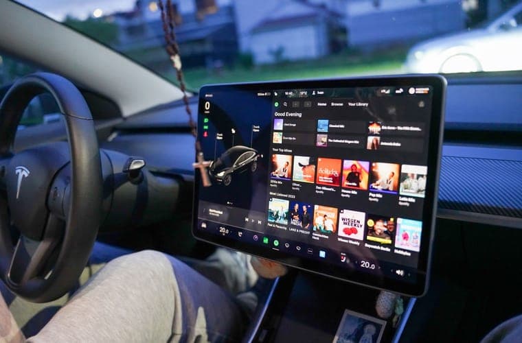Close-up of a Tesla touchscreen showing the media and entertainment menu