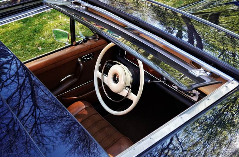 Car interior looking up through an open roof aperture