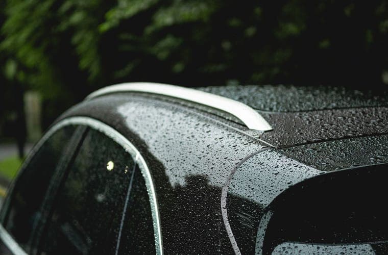 Rain beading on a car roof and side glass