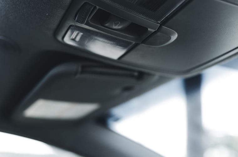 Dim car interior lit only by its own cabin lighting