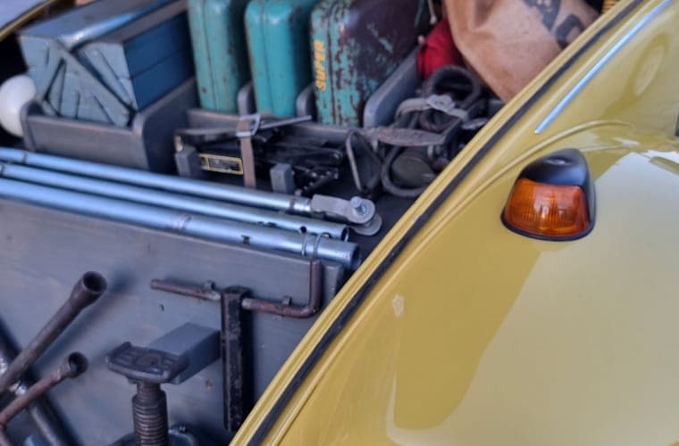 Open front trunk of a car with bags packed inside