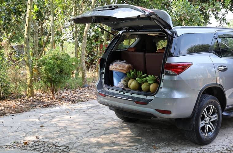 Open car cargo area with groceries loaded in the back